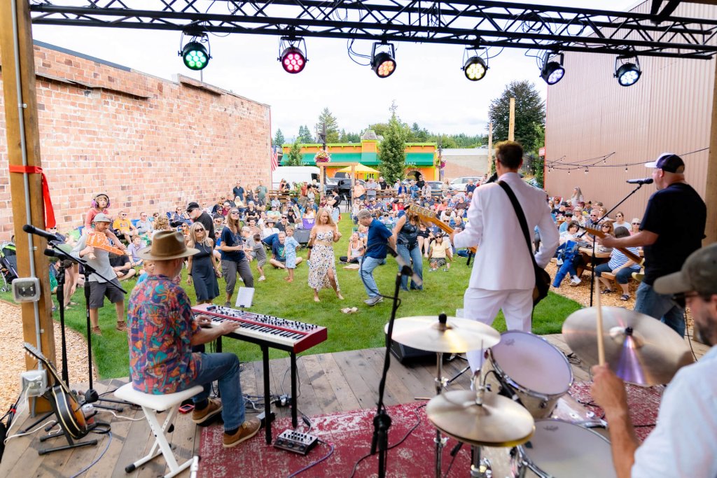 People dance during an outdoor concert