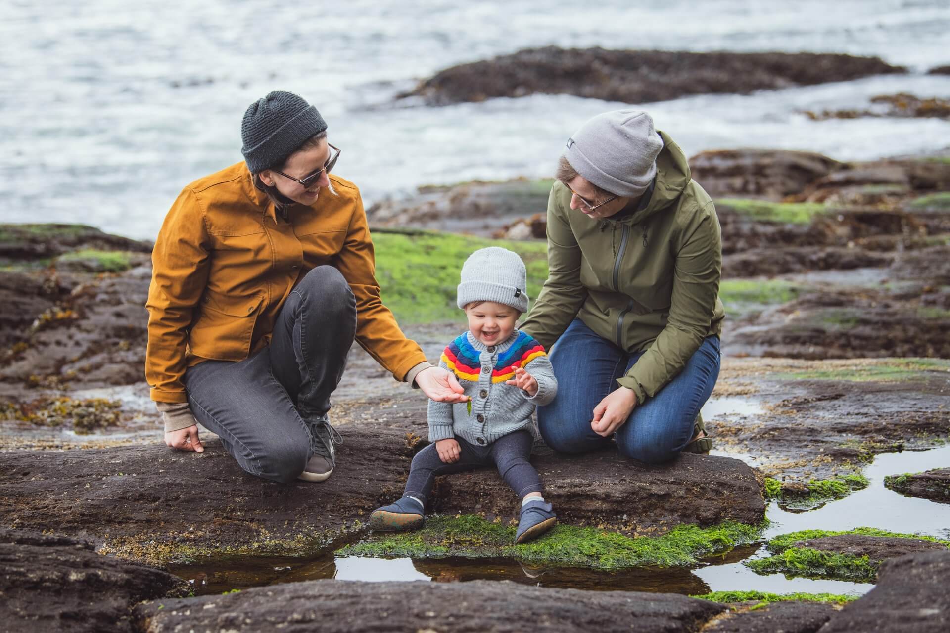 Two women and a toddler look at tide pools near Port Angeles.