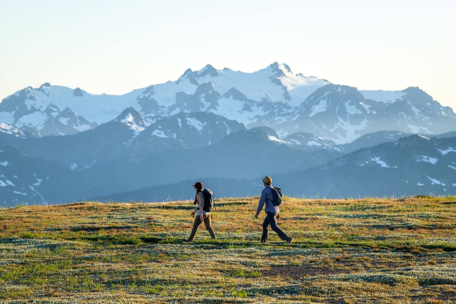 Two people going hiking in Washington at Obstruction Point with mountains in the background