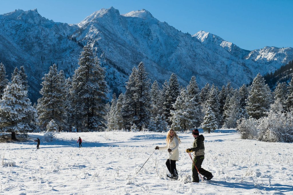 Photo of two adults snowshoeing