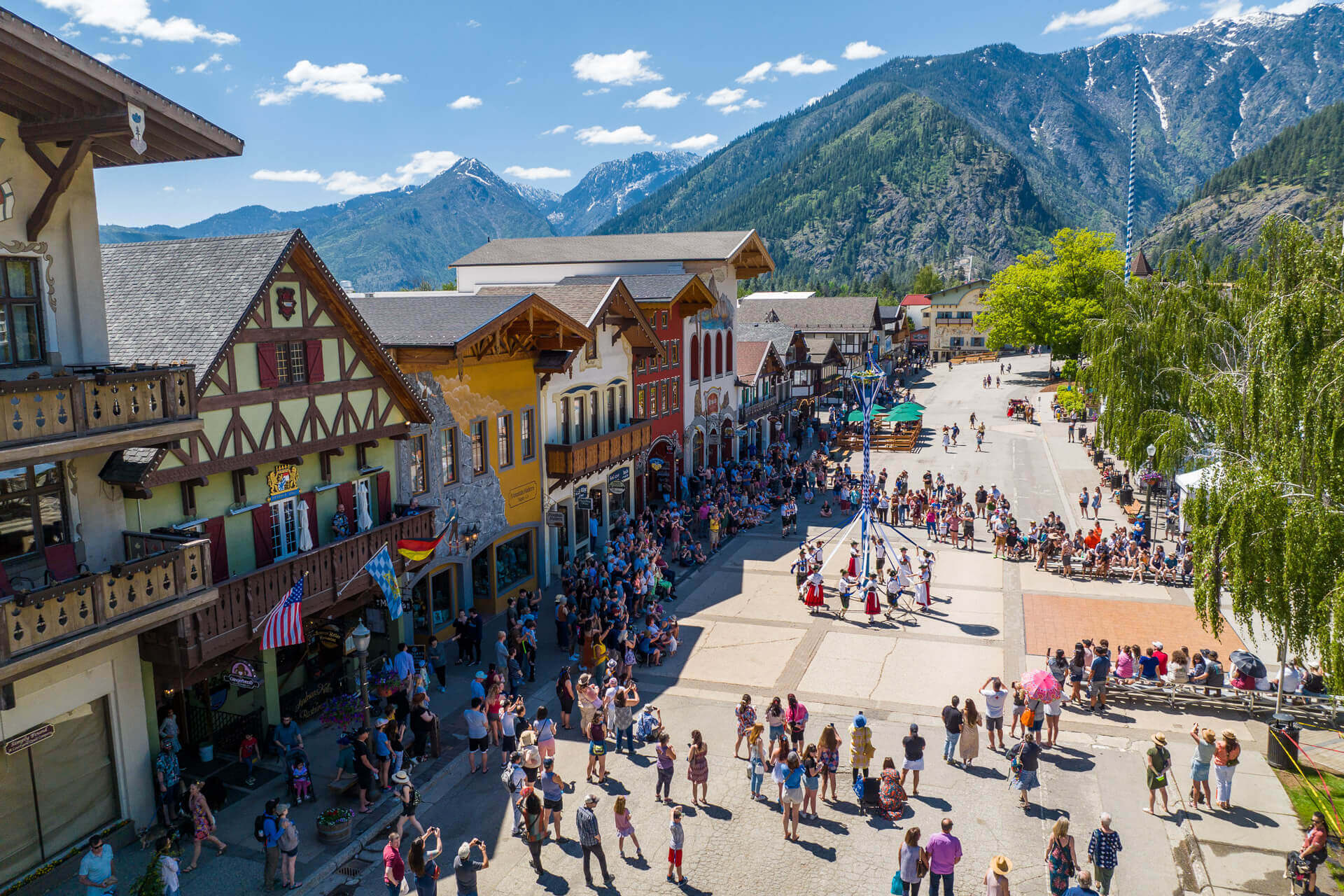 Photo of people dancing around a maypole in downtown Leavenworth during a festival
