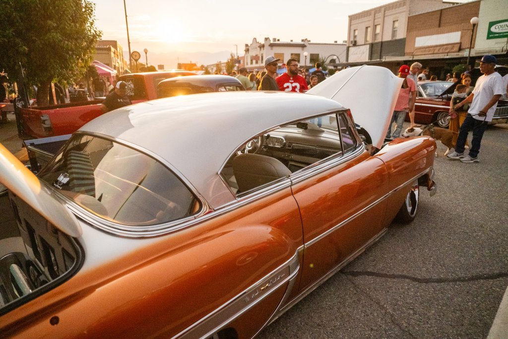 People look at a classic car 
