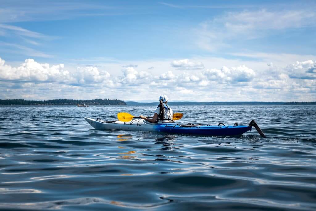 A woman kayaking in Glen Cove near Gig Harbor, WA. 