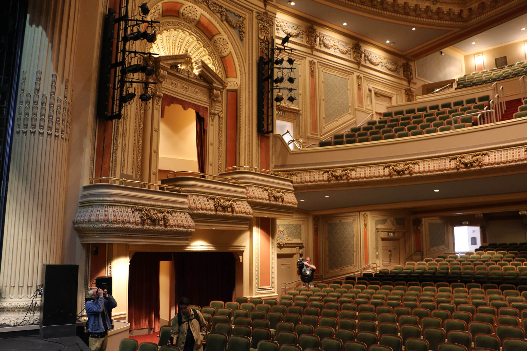 People set up film equipment inside a historic Washington theater