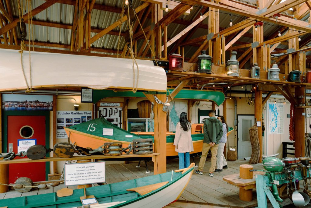 A photo of three people looking at exhibits in a maratime museum in Poulsbo