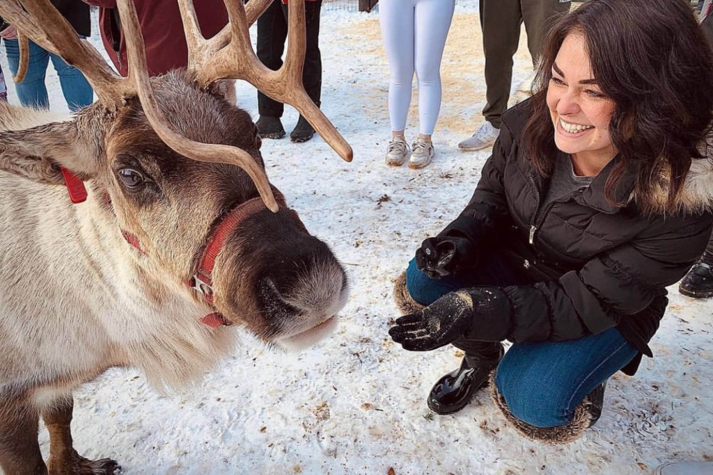 Photo of a woman feeding a reindeer in Leavenworth Washington