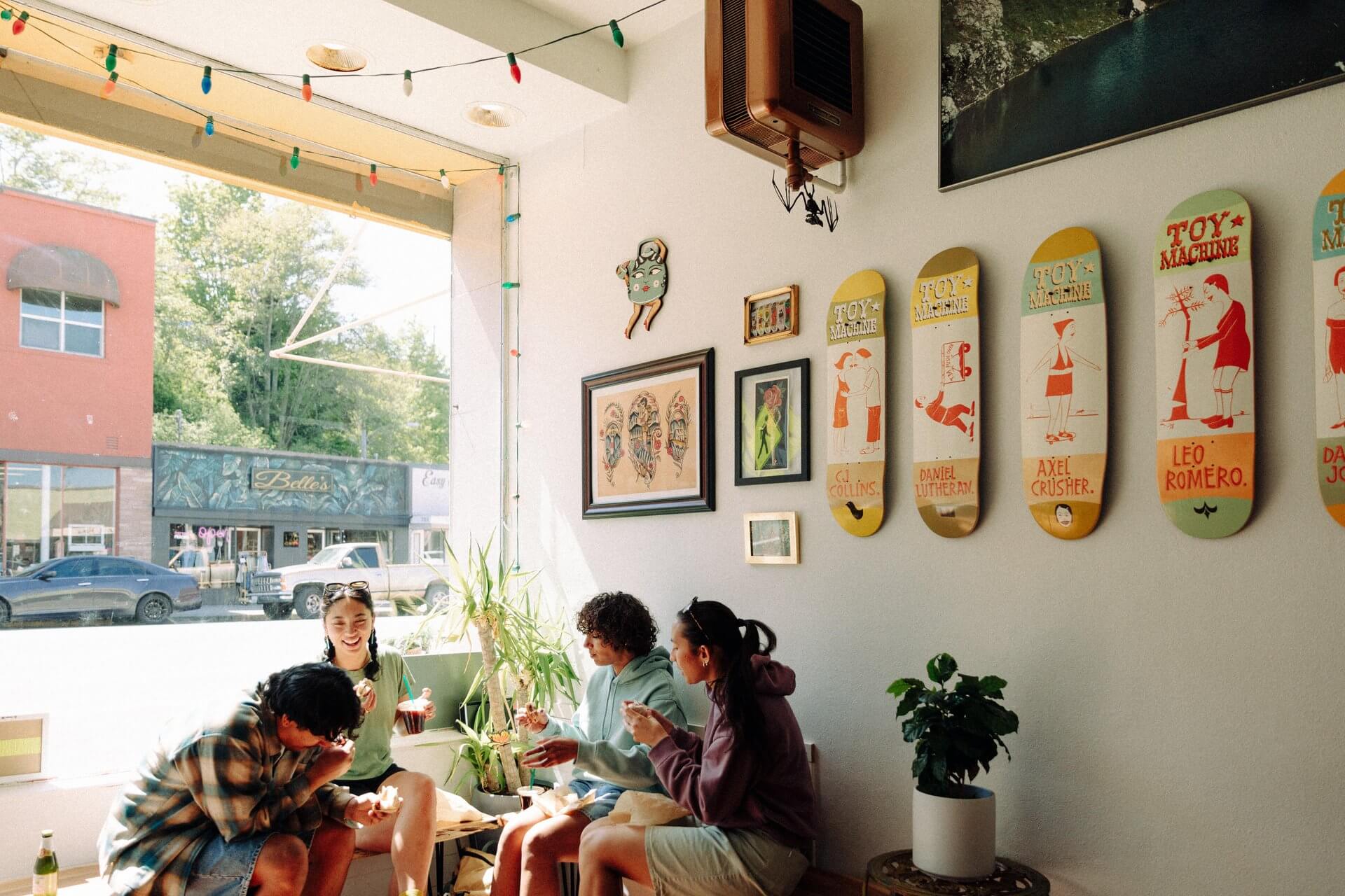 A group of people sit in front of a large window at a bagel shop in Port Angeles. 
