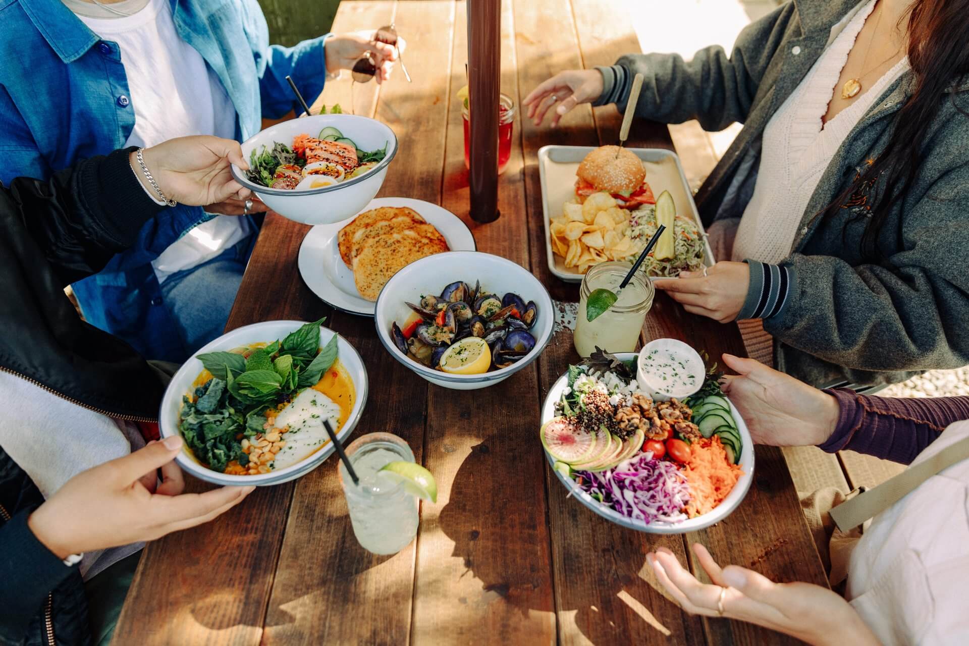 Four people sit at a table filled with food at a restaurant in Port Angeles. 