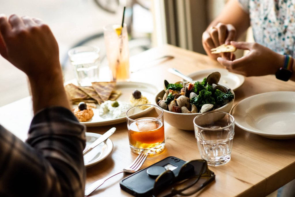 Two people enjoy a meal and cocktails at The Black Cypress in Pullman