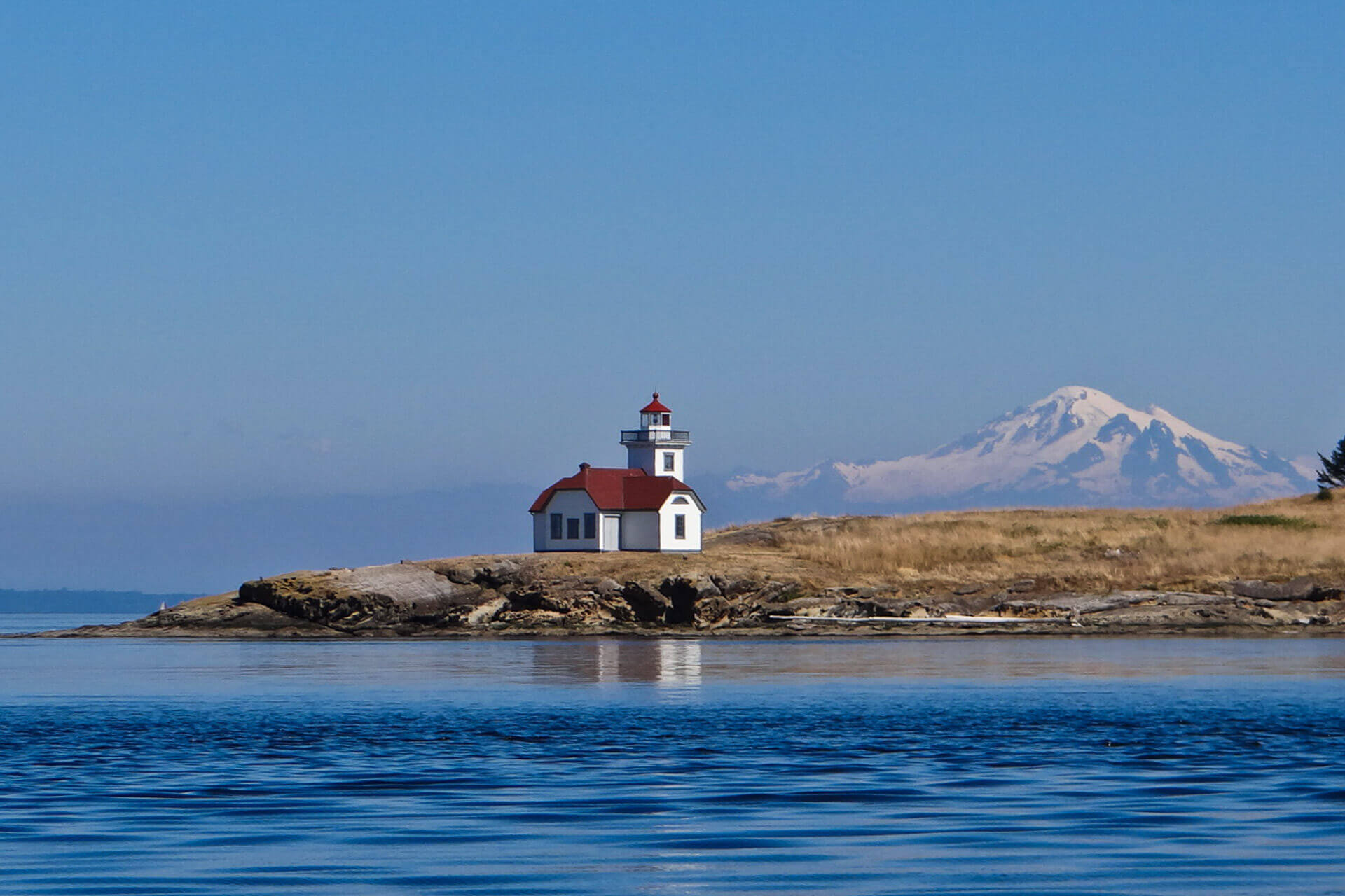 Patos Island sits near the water with a mountain in the background.