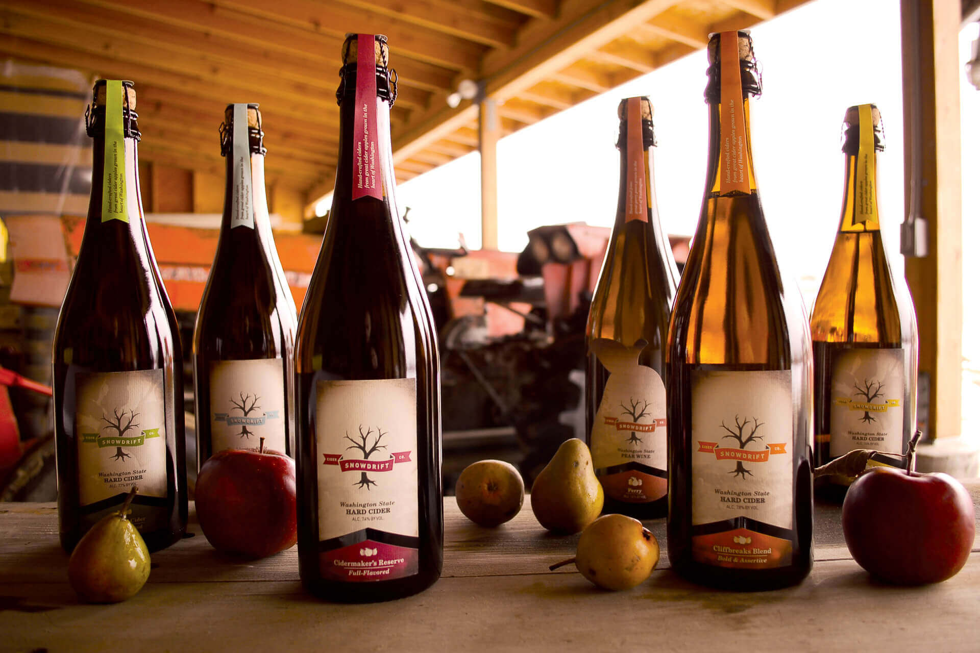 Bottles of apple cider sit on a table