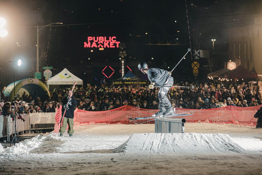 A skier grinds on a railing in front of a crowd during the Rails and Ales event, one of many things to do in Wenatchee.